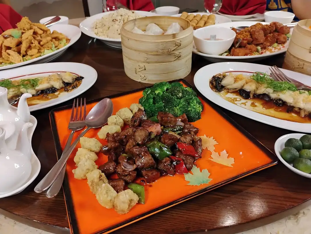 A round table filled with Chinese dishes